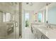 Bright bathroom offers double sink vanity, glass enclosed shower and natural lighting at 5642 N Scottsdale Rd, Paradise Valley, AZ 85253