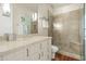 Bathroom boasting a granite vanity, large mirror, and glass enclosed shower with bench at 5642 N Scottsdale Rd, Paradise Valley, AZ 85253