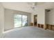 Unfinished bedroom showing sliding glass door, ceiling fan, and interior structural work at 5642 N Scottsdale Rd, Paradise Valley, AZ 85253