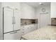 Bright kitchen features white cabinetry, granite countertops, and stainless steel appliances at 5642 N Scottsdale Rd, Paradise Valley, AZ 85253