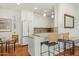 Compact kitchen featuring granite countertops, breakfast bar, and stainless-steel appliances at 5642 N Scottsdale Rd, Paradise Valley, AZ 85253