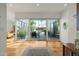 Bright living space with hardwood floors and a large sliding glass door to the patio at 5642 N Scottsdale Rd, Paradise Valley, AZ 85253