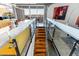 Modern railing detail highlights the wooden staircase connecting to the open living space and kitchen at 6850 E Main St # 4416, Scottsdale, AZ 85251