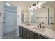 Bathroom featuring a double vanity with marble countertop, mirrors, modern lights, and a shower and tub at 6885 E Cochise Rd # 219, Paradise Valley, AZ 85253