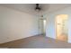 Bright bedroom with neutral carpet features an entryway to a bathroom with a shower at 6885 E Cochise Rd # 219, Paradise Valley, AZ 85253