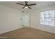 Neutral bedroom includes a ceiling fan, window with blinds, and access to a closet at 6885 E Cochise Rd # 219, Paradise Valley, AZ 85253