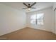 Neutral bedroom featuring a ceiling fan and window for natural light, and neutral carpet at 6885 E Cochise Rd # 219, Paradise Valley, AZ 85253