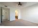 Bedroom features neutral carpet, an entryway to a bathroom, and a ceiling fan at 6885 E Cochise Rd # 219, Paradise Valley, AZ 85253
