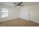 Bright bedroom features neutral carpet, a window with blinds, and a modern ceiling fan at 6885 E Cochise Rd # 219, Paradise Valley, AZ 85253