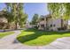 Manicured landscaping frames the condominium exterior with mature trees and lush green lawn at 6885 E Cochise Rd # 219, Paradise Valley, AZ 85253