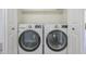 Laundry room with white front load washing machine and dryer at 6885 E Cochise Rd # 219, Paradise Valley, AZ 85253
