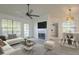 Bright living room featuring a modern fireplace, ceiling fan and a stylish grey patterned rug at 6885 E Cochise Rd # 219, Paradise Valley, AZ 85253
