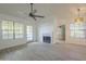 Open living room with fireplace, windows, and a ceiling fan at 6885 E Cochise Rd # 219, Paradise Valley, AZ 85253