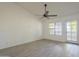 Bright living room with ceiling fan, wood-look floors, and door to balcony at 6885 E Cochise Rd # 219, Paradise Valley, AZ 85253