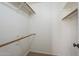 White walk-in closet with brown railings and neutral carpet at 6885 E Cochise Rd # 219, Paradise Valley, AZ 85253
