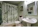 Bathroom featuring a white vanity sink, toilet, and shower with leaf patterned curtain at 7511 E Desert Vista Rd, Scottsdale, AZ 85255