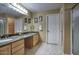 Bathroom with double sinks, granite countertop, and large mirror at 7511 E Desert Vista Rd, Scottsdale, AZ 85255