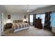 Main bedroom featuring a ceiling fan, patterned bedspread, and large windows at 7511 E Desert Vista Rd, Scottsdale, AZ 85255