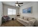 Relaxing living room featuring a sofa, chair, ceiling fan and window at 7511 E Desert Vista Rd, Scottsdale, AZ 85255