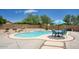 A gorgeous backyard pool with a table, chairs, and landscaping at 7511 E Desert Vista Rd, Scottsdale, AZ 85255