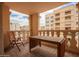 Balcony with a table and chair overlooks the complex amenities and offers great views of the building at 7920 E Camelback Rd # 408, Scottsdale, AZ 85251