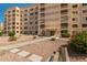 Exterior shot of a tan building showcasing its architectural facade with balconies and walkways and landscaped entrance at 7920 E Camelback Rd # 408, Scottsdale, AZ 85251