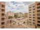 View of the complex showing buildings, amenities, walkways, and landscaping, with blue sky and white clouds at 7920 E Camelback Rd # 408, Scottsdale, AZ 85251