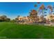 Scenic view of lush green golf course with a pond and building in the background under a clear blue sky at 7920 E Camelback Rd # 408, Scottsdale, AZ 85251