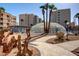 Community pool featuring palm trees and a unique glass enclosure at 7920 E Camelback Rd # 408, Scottsdale, AZ 85251