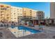 Community pool featuring lounge seating and red umbrellas for shade at 7920 E Camelback Rd # 408, Scottsdale, AZ 85251