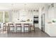 Bright, modern kitchen with white cabinets, stainless steel appliances, an island with seating, and elegant pendant lighting at 7982 W Griswold Rd, Peoria, AZ 85345