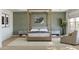 Comfortable bedroom showcasing a stylish bed, coordinated nightstands, and ample natural light from the large window at 7982 W Griswold Rd, Peoria, AZ 85345