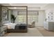 Serene main bedroom featuring a four-poster bed, cozy sitting area, and a neutral color scheme for a peaceful retreat at 7982 W Griswold Rd, Peoria, AZ 85345