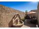 A serene courtyard featuring a water fountain and an umbrella-covered seating arrangement at 8082 E Via Del Vencino --, Scottsdale, AZ 85258