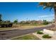 Scenic neighborhood view features a lush green golf course, manicured landscaping, and majestic mountain views at 8082 E Via Del Vencino --, Scottsdale, AZ 85258