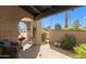 Cozy covered patio features brick columns, a comfortable wicker chair, and views of the surrounding neighborhood at 8082 E Via Del Vencino --, Scottsdale, AZ 85258