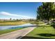 Scenic pond view featuring a paved walking path, lush greenery, and a variety of waterfowl at 8082 E Via Del Vencino --, Scottsdale, AZ 85258