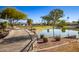 Picturesque pond view framed by mature trees, a walking path, and verdant green spaces at 8082 E Via Del Vencino --, Scottsdale, AZ 85258