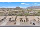 Wide shot of a desert community, showcasing tan-colored homes and the iconic Superstition Mountains in the background at 8096 E Lavender Dr, Gold Canyon, AZ 85118