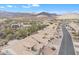 Aerial view of a desert community, showcasing uniform beige homes nestled among arid landscape and winding roads at 8096 E Lavender Dr, Gold Canyon, AZ 85118