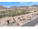 Panoramic view of a desert community dotted with tan homes and lush native greenery, set against a backdrop of majestic mountains at 8096 E Lavender Dr, Gold Canyon, AZ 85118