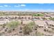 Bird's-eye view of a sprawling desert community next to a golf course and lush native greenery at 8096 E Lavender Dr, Gold Canyon, AZ 85118
