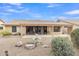 The backyard features a covered patio, desert landscaping, and rock features at 8096 E Lavender Dr, Gold Canyon, AZ 85118