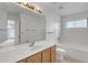 Bright bathroom features a single sink vanity, a large mirror, and a tub-shower combination at 8096 E Lavender Dr, Gold Canyon, AZ 85118