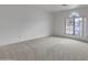 Bright bedroom features a decorative window and neutral carpet providing a comfortable atmosphere at 8096 E Lavender Dr, Gold Canyon, AZ 85118