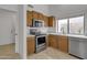 Cozy kitchen boasts stainless steel appliances and warm wood cabinets at 8096 E Lavender Dr, Gold Canyon, AZ 85118