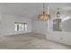 Spacious living room featuring neutral carpet, bright light, and a chandelier at 8096 E Lavender Dr, Gold Canyon, AZ 85118