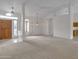 Spacious living room features a high ceiling, neutral carpet, and a chandelier at 8096 E Lavender Dr, Gold Canyon, AZ 85118
