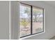 Window view of the landscape with mature trees and desert plants, complemented by a modern window frame at 8096 E Lavender Dr, Gold Canyon, AZ 85118