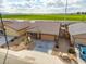 An aerial view of a single story house with a tile roof, desert landscaping, and a two car garage at 8552 S 258Th Dr, Buckeye, AZ 85326